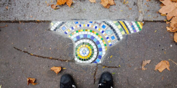 The guerrilla artist filling Europe’s potholes with colourful mosaics