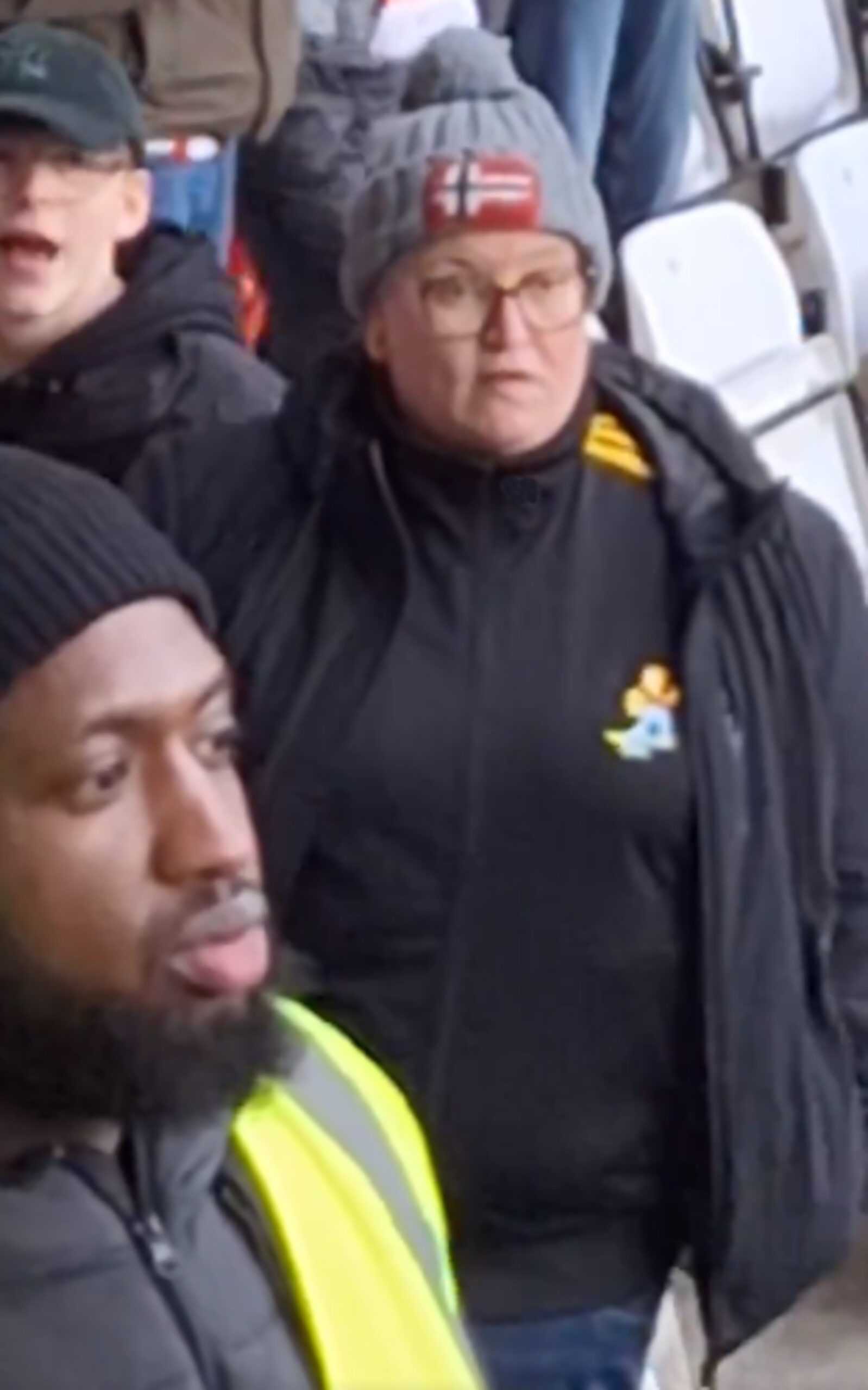 Moment woman tells footy fans to "come outside" for scrap