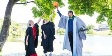 New University of Stirling graduates Heather Gibson (left), from Glasgow, and Robyn MacPherson, from Livingston, shared graduation day with Scottish basketball great Kieron Achara. Heather, 28, and Robyn, 32, graduated with a BA (Hons) Professional Education (Primary) © Stirling University
