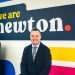 An image of Vincent Goldie standing in front of the Newton Property Management sign.
